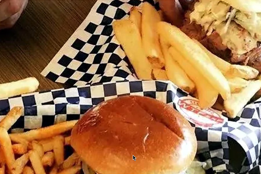 WTF EXP fries and buns on branded checkered paper
